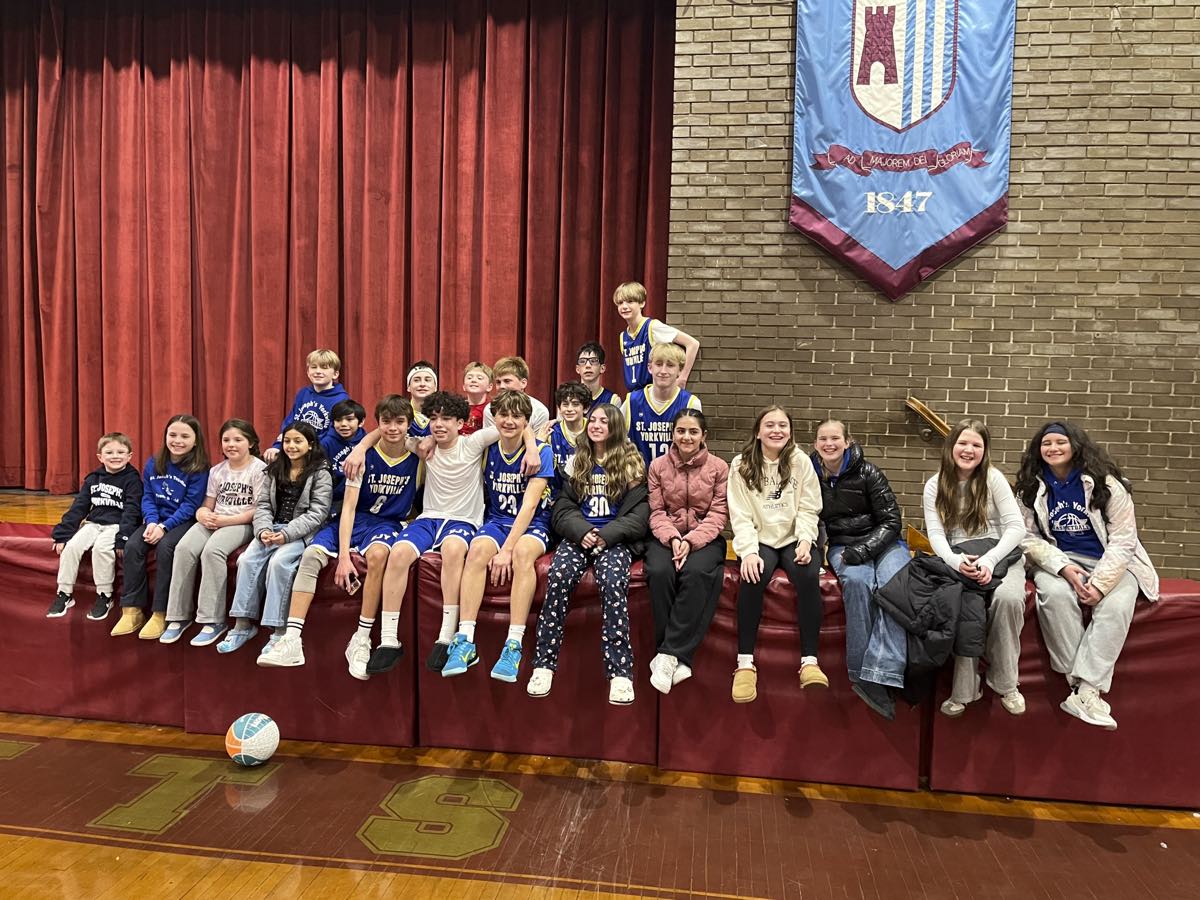 Players and friends from the St. Joseph's Yorkville CYO basketball program together in the parish gym.